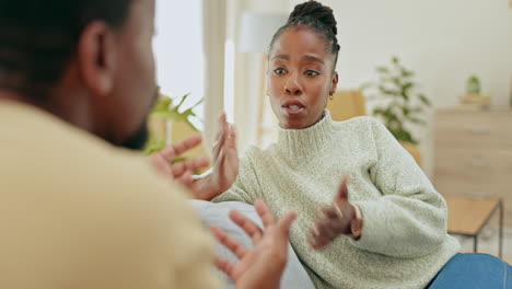 Black-couple,-argument-and-talking-on-sofa