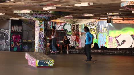 skateboarders performing tricks in urban skatepark