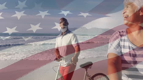 animation of flag of usa over happy senior biracial couple with bikes on beach