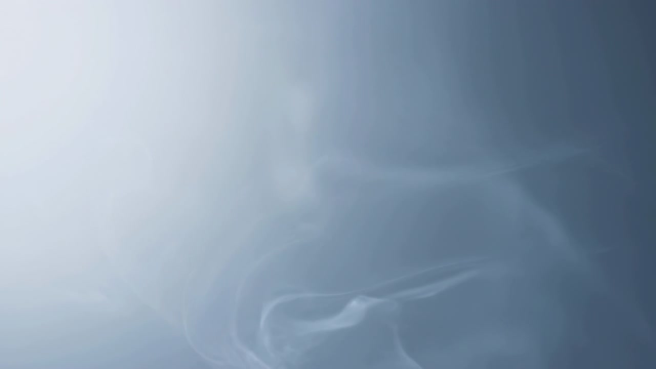 Translucent smoke and feathery curls create layered ethereal texture across cool blue frame, with denser detail in lower right and spacious pale negative area at upper left for copy