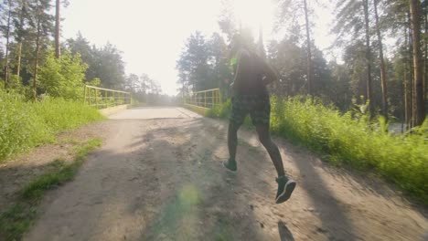 man running through forest
