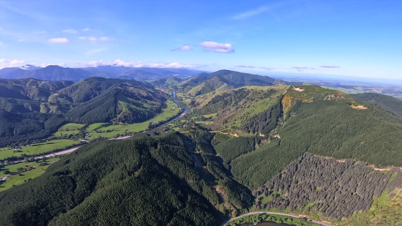 Stunning aerial shot flying up the Motueka valley in New Zealand on a sunny day