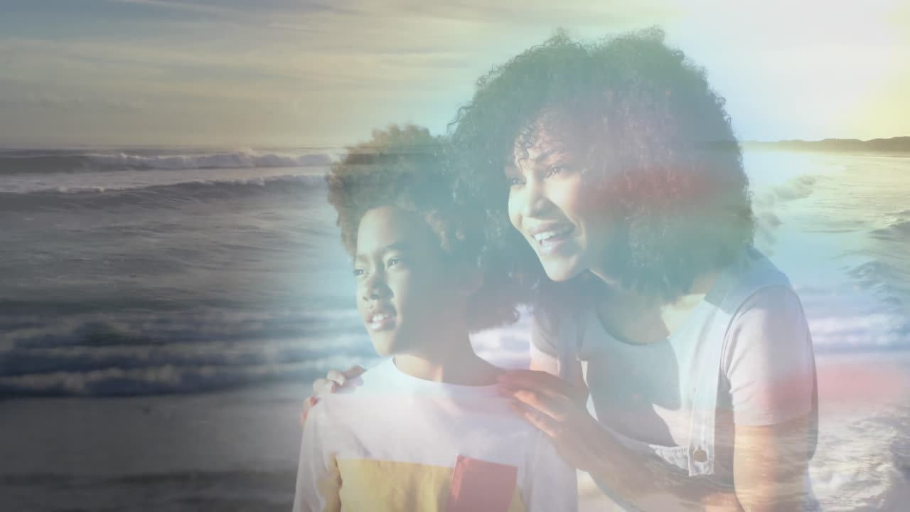Animation of happy african american mother and son at beach on sunny day smiling over sea