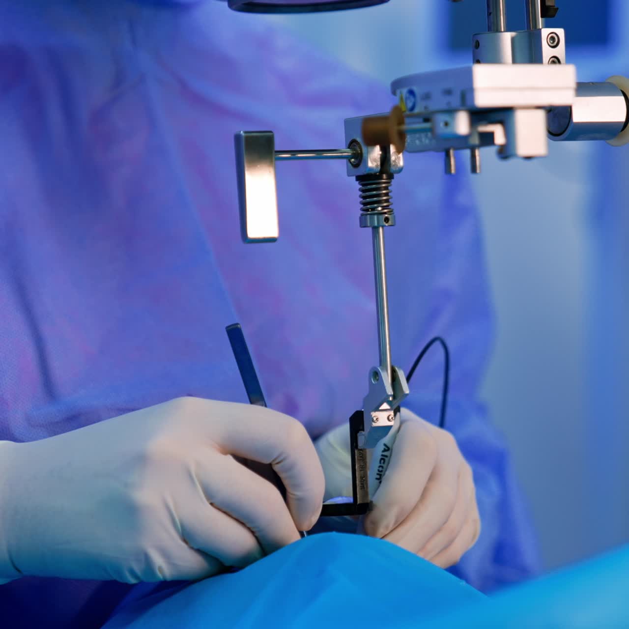 Doctor works on the operation looking through the lens. Ophthalmology procedure in clinics