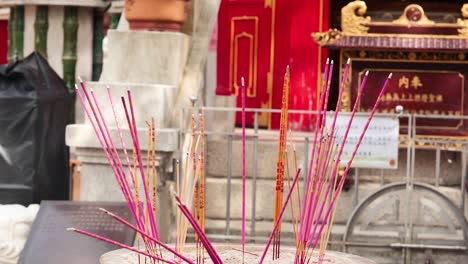 incense sticks burning in a temple setting