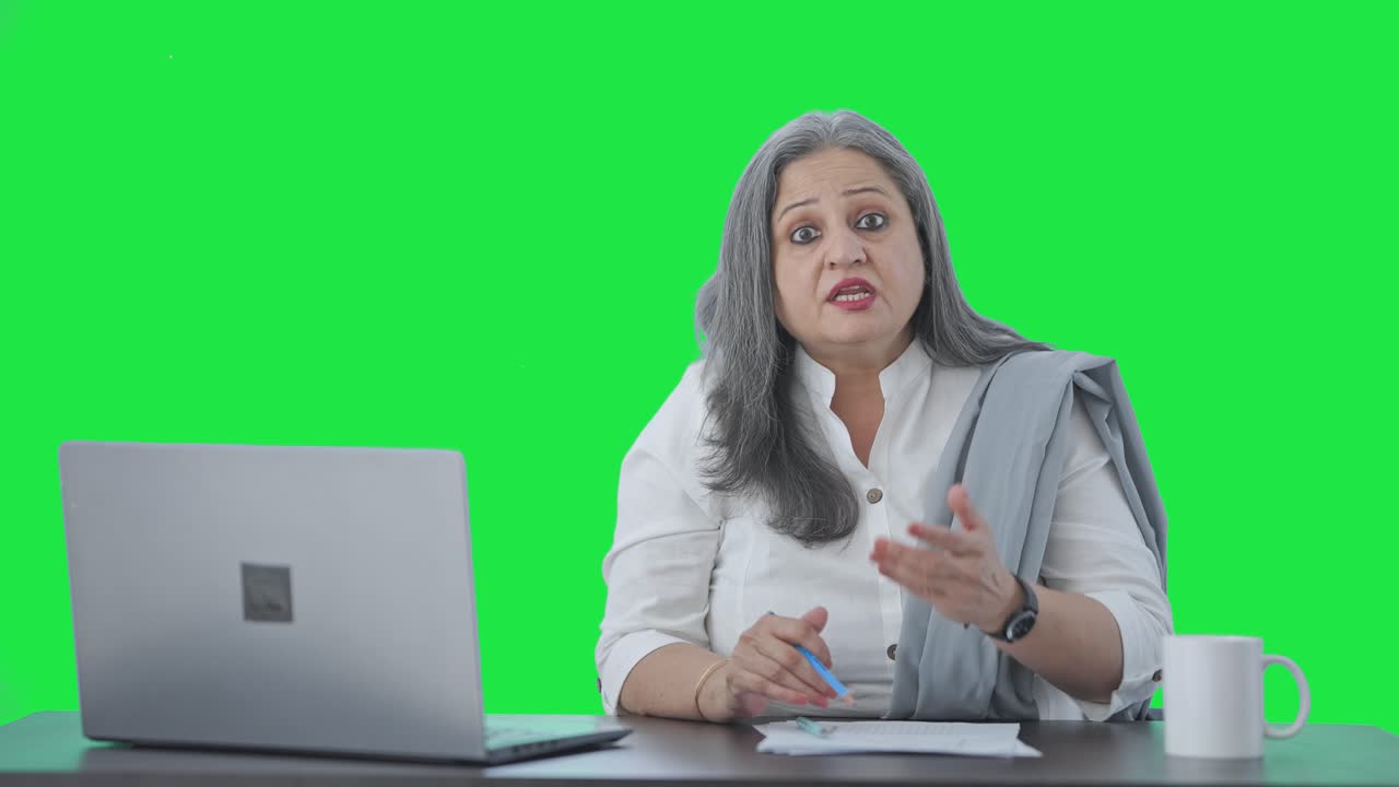 Angry Indian senior businesswoman shouting to someone Green screen