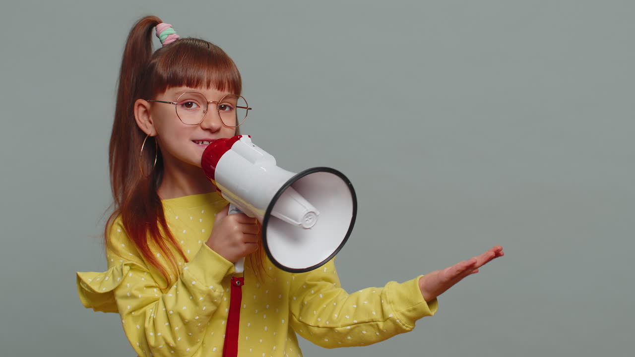 Toddler girl scream shout in megaphone loudspeaker announces discounts sale announcing advertisement