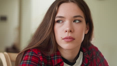 upset young woman looks aside in room closeup sad long haired lady heard tragical news about