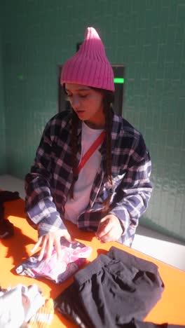 woman sorting clothes at a donation center