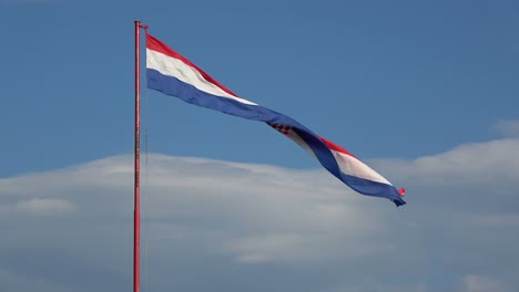 4k. beautiful large flag of croatia waving in the wind. blue sky