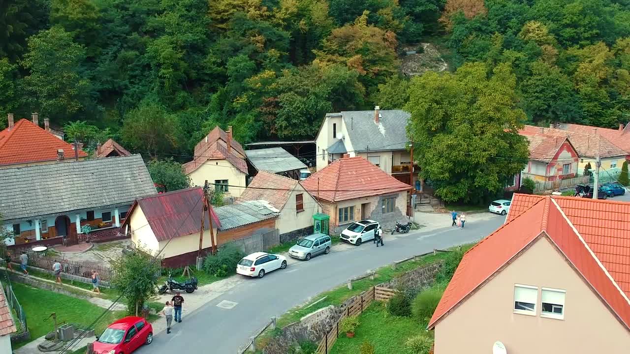 Drone view of a small hungarian village, deep inside Pest county, surrounded by mountain forrest, visited by tourists