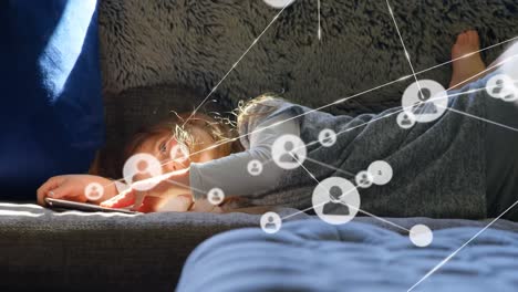 iconos de perfil interconectándose con líneas sobre chica caucásica usando teléfono inteligente mientras está acostada en el sofá