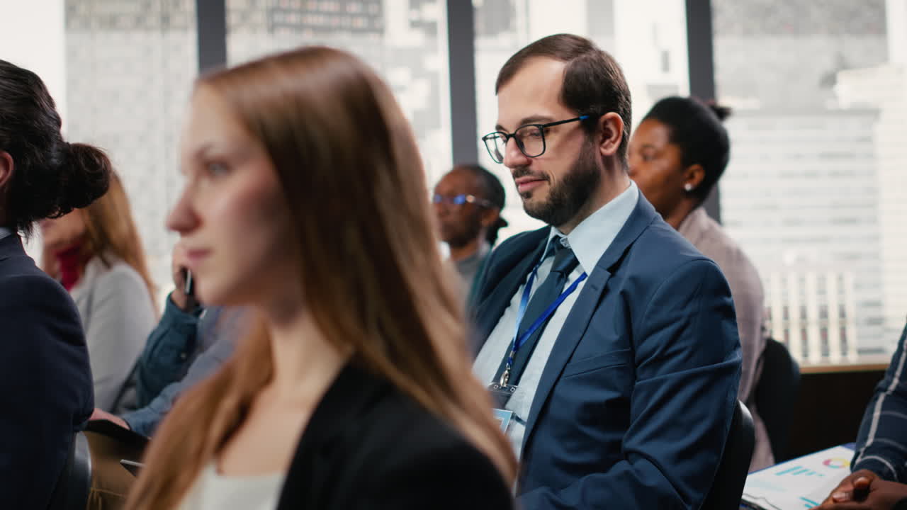 Corporate man attends conference event and writing ideas on laptop