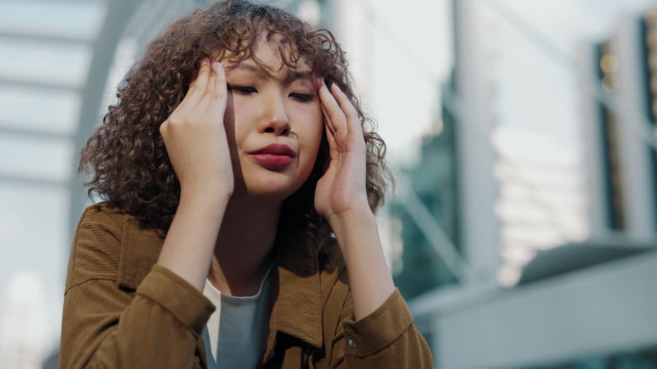 Woman Experiencing Headache Outdoors