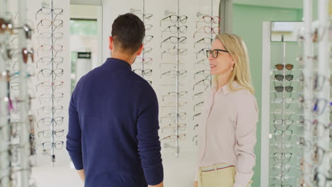 Friendly-optician-fitting-a-pair-of-glasses