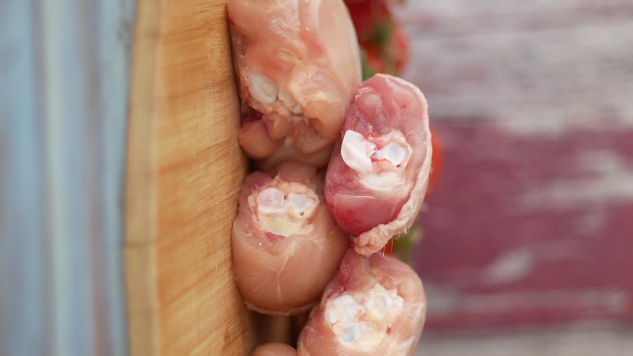 Raw Chicken Thighs on a Wooden Cutting Board