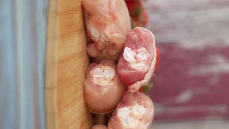 raw chicken thighs on a wooden cutting board