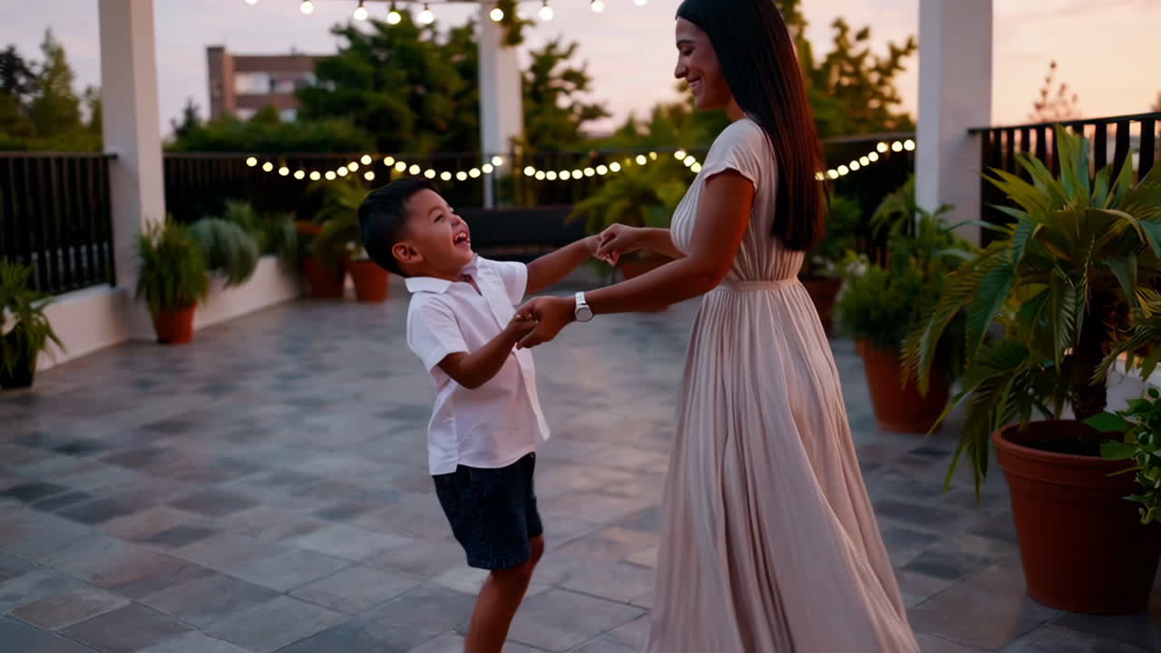 Mother and Son Dancing on a Rooftop Patio at Sunset