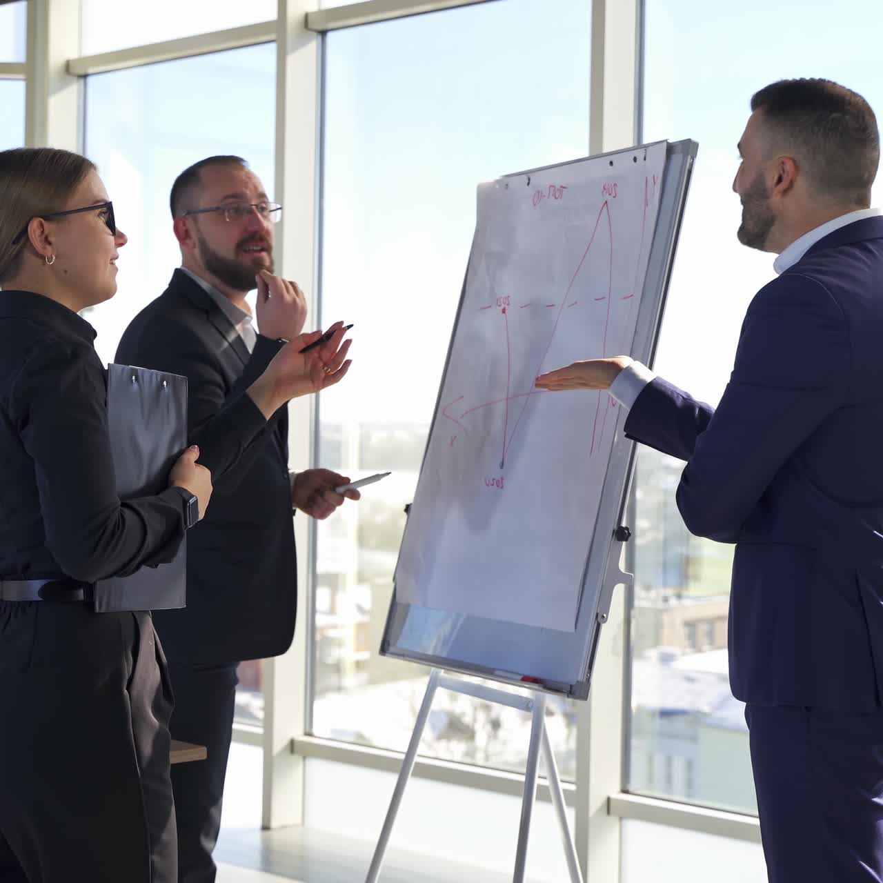 Group of young office employees. Businesspeople men and woman discussing a project in office room meeting. A team of attractive business partners
