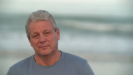 Senior-man-with-a-slight-smile-portrait-against-the-sea