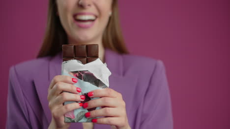 woman eating chocolate bar