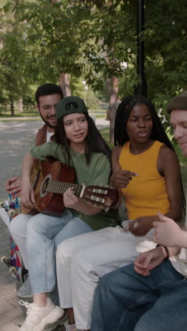 friends playing music in the park