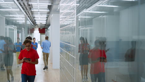 business people walking on office corridor with devices. manager hurrying up.