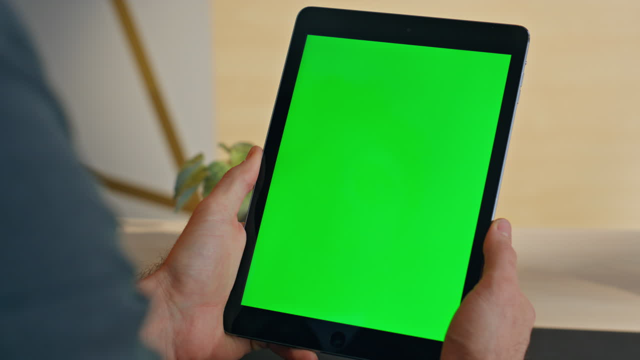 Unknown worker using mockup tablet working remotely home closeup. Person reading