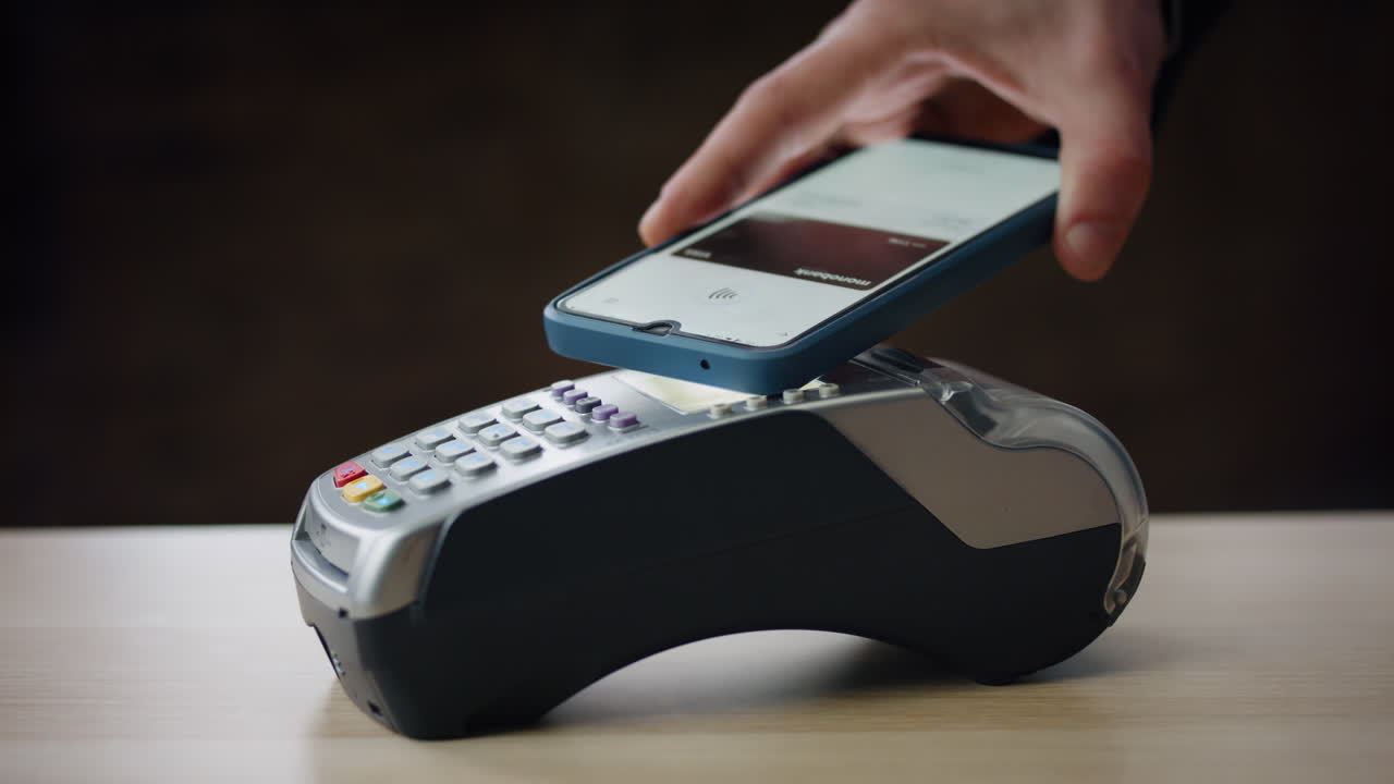 Contactless payment bank terminal using smartphone with nfc technologies closeup