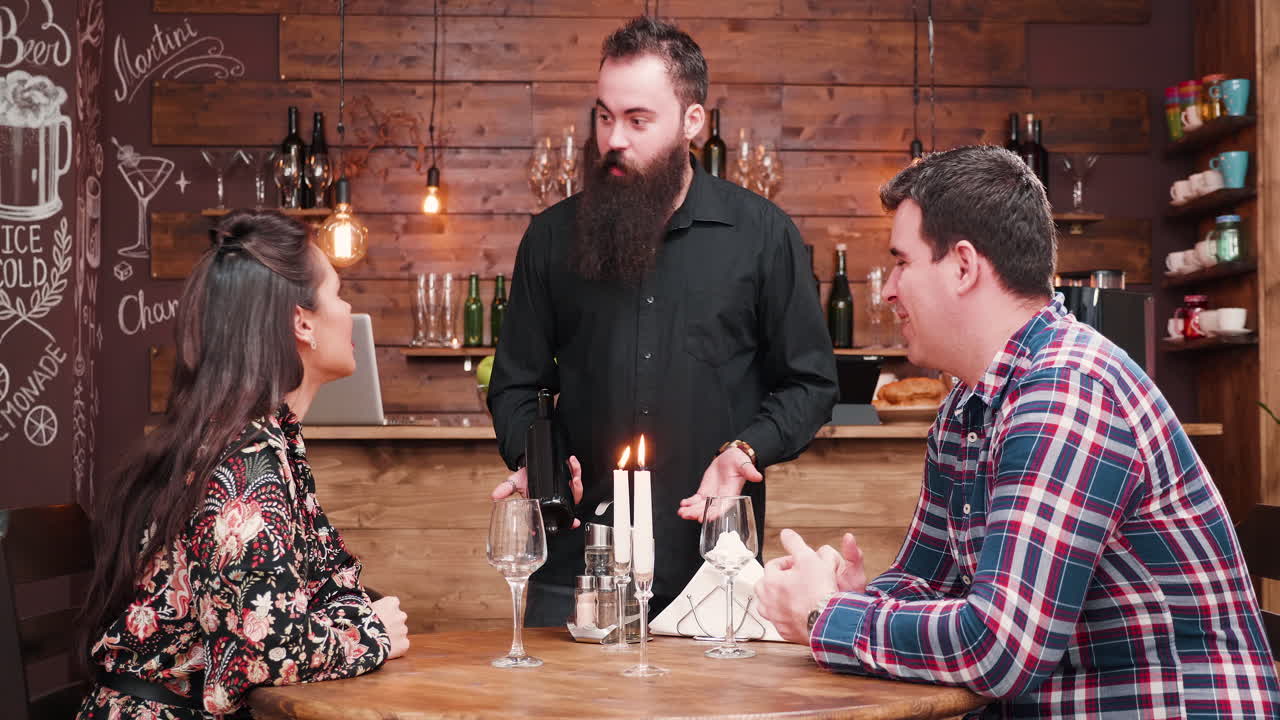 Couple enjoying a date night at a restaurant with wine service