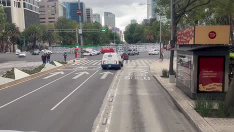 mexico city street scene: busy urban traffic and cityscape