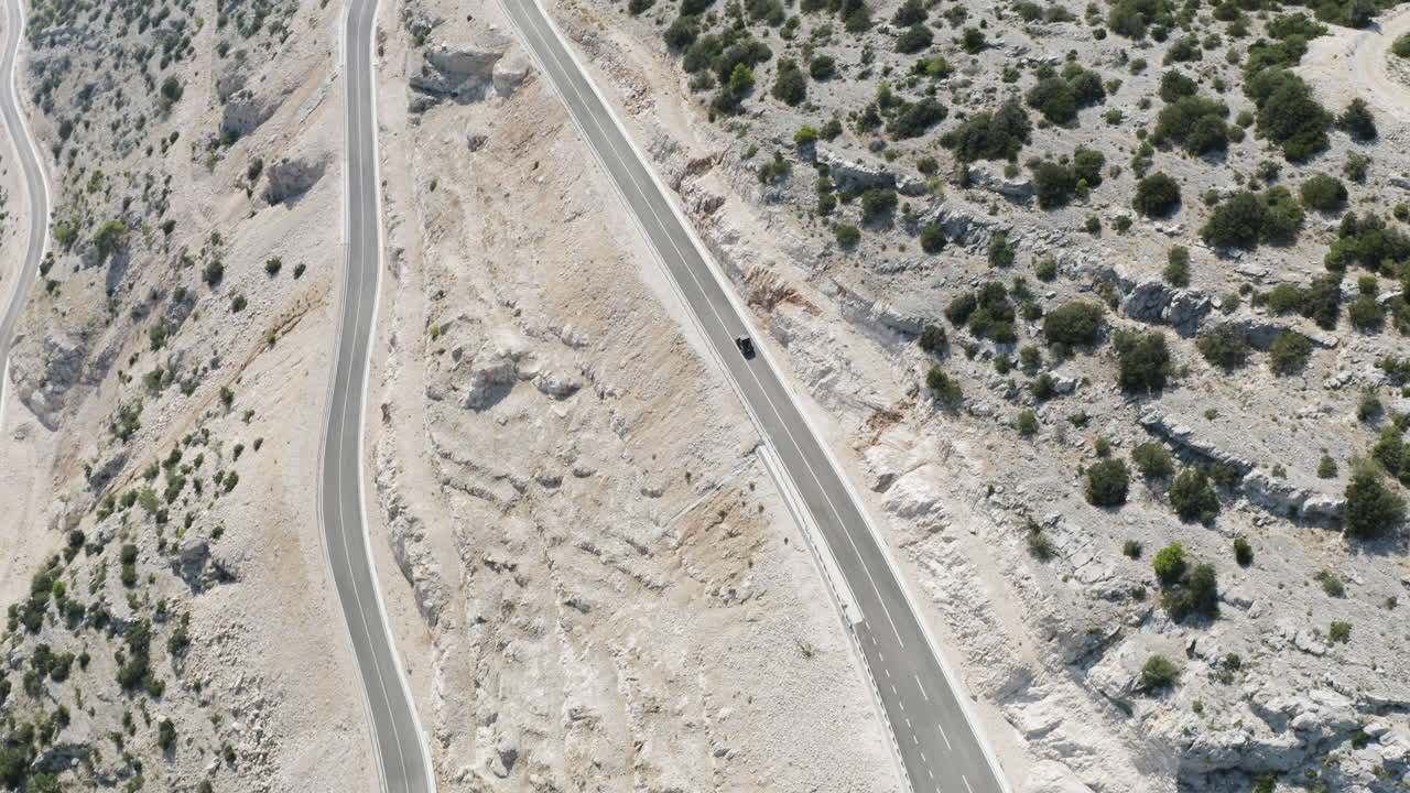 Wide Drone Shot of Two Dune Buggies Descending Large Empty Mountain Roads