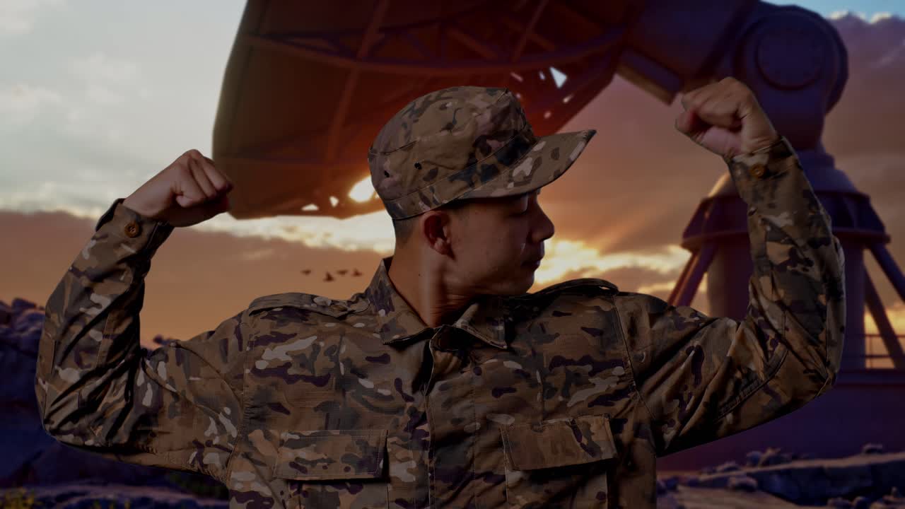 Close Up Of Asian Man Soldier Smiling And Flexing His Bicep While Standing With Satellite Dish