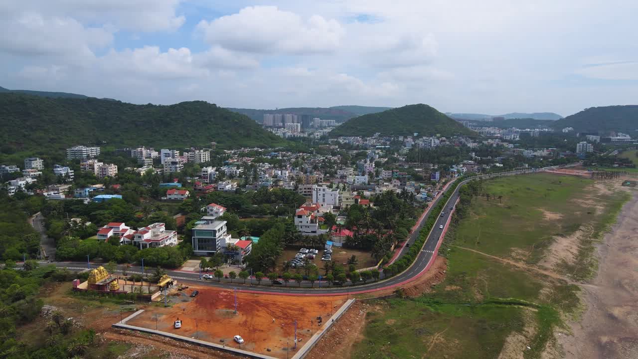 Aerial drone shot of Vizag city, capturing the harmonious blend of urban life and the vast ocean on its doorstep.