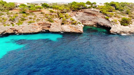 aerial view lagoon of rocky coast mallorca island, spain, panning