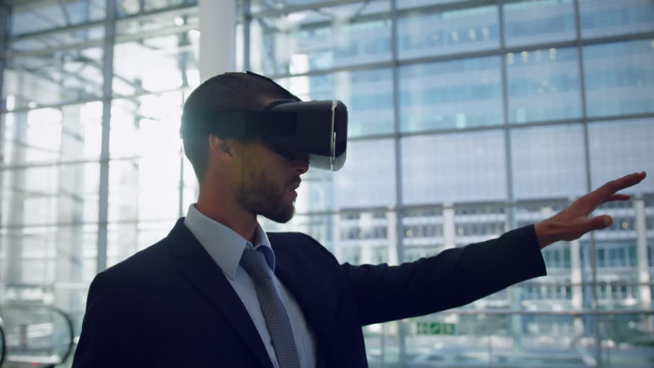Businessman using virtual reality headset in the lobby at office 4k ...