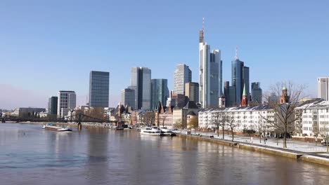 Frankfurt-Skyline-And-Eiserner-Steg-Over-Main-River-With-Barge-Ship-From-Alte-Brucke-In-Frankfurt-am-Main,-Germany