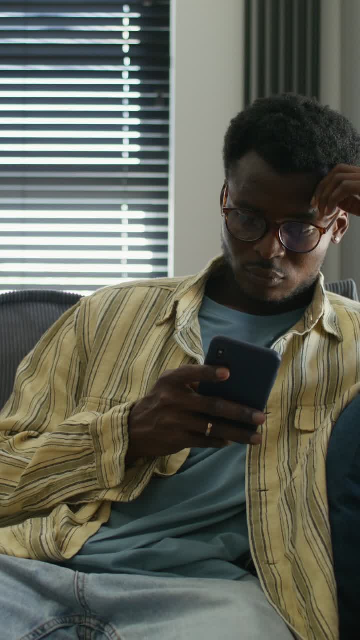 Man using smartphone on a couch