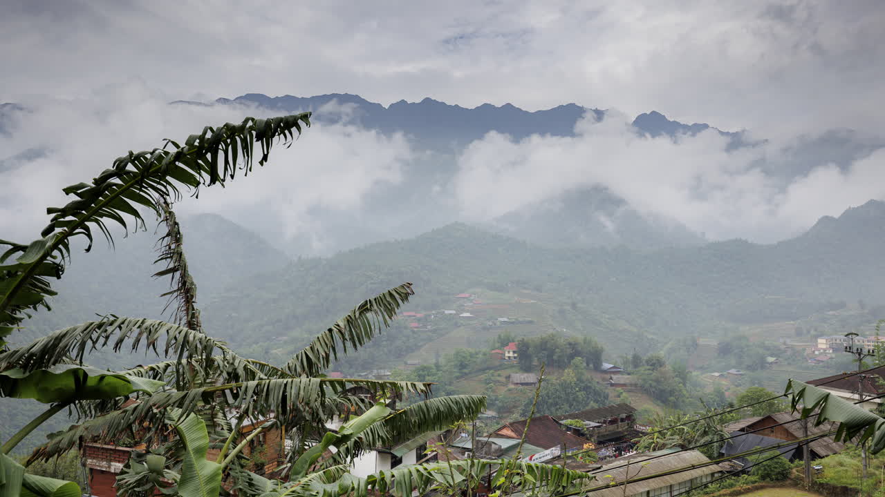 A stunning timelapse of the Sapa mountain landscape in Vietnam, with clouds drifting across the peaks as the camera gradually zooms in for a closer view.