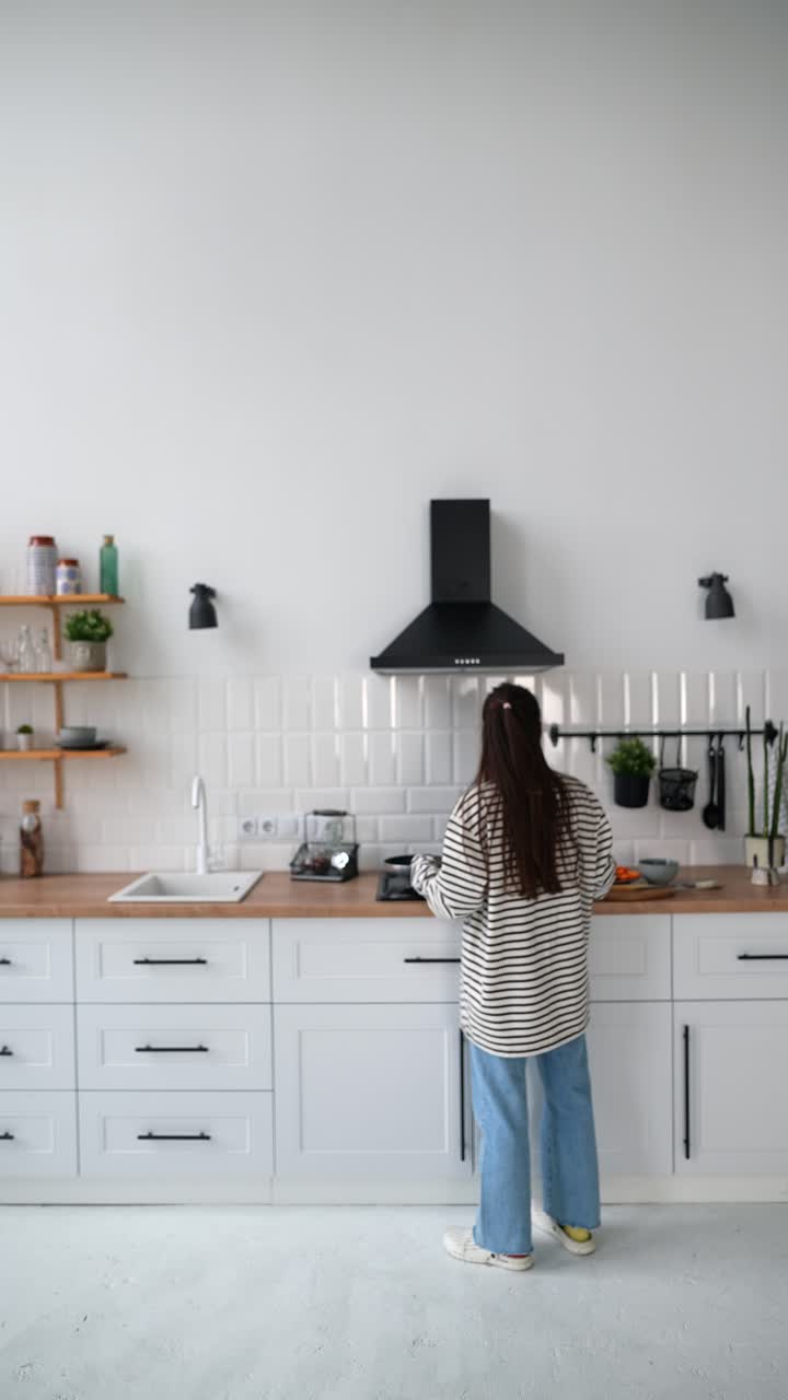 mujer cocinando en una cocina moderna
