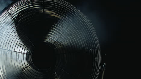 Fan-blades-rotate-in-rays-of-light-and-fog