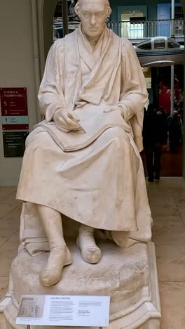 visitors observe a statue in the museum