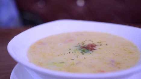a child eats pumpkin soup in a restaurant.