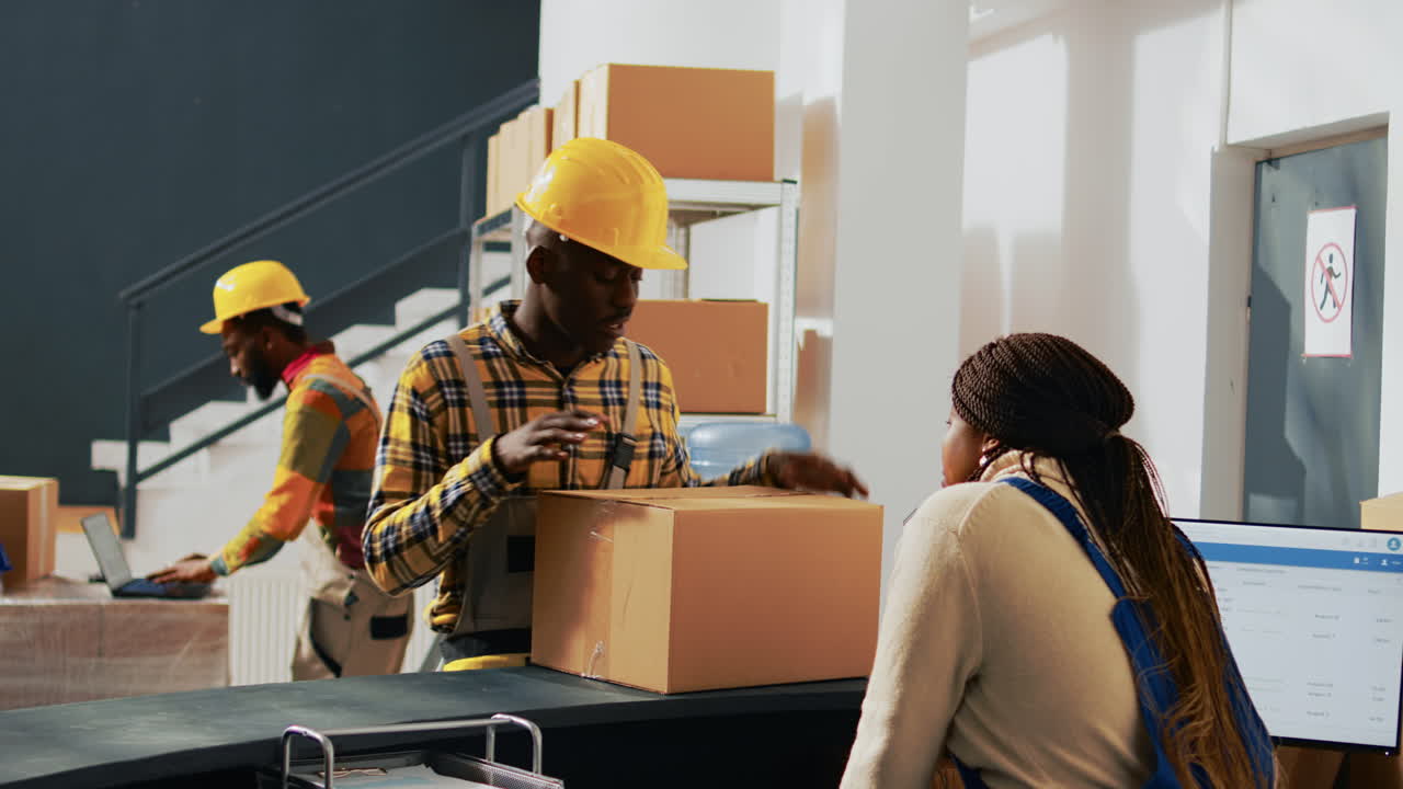 Warehouse workers with boxes in shipping and receiving area