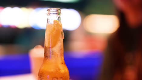 close-up of beer bottle with lime slice