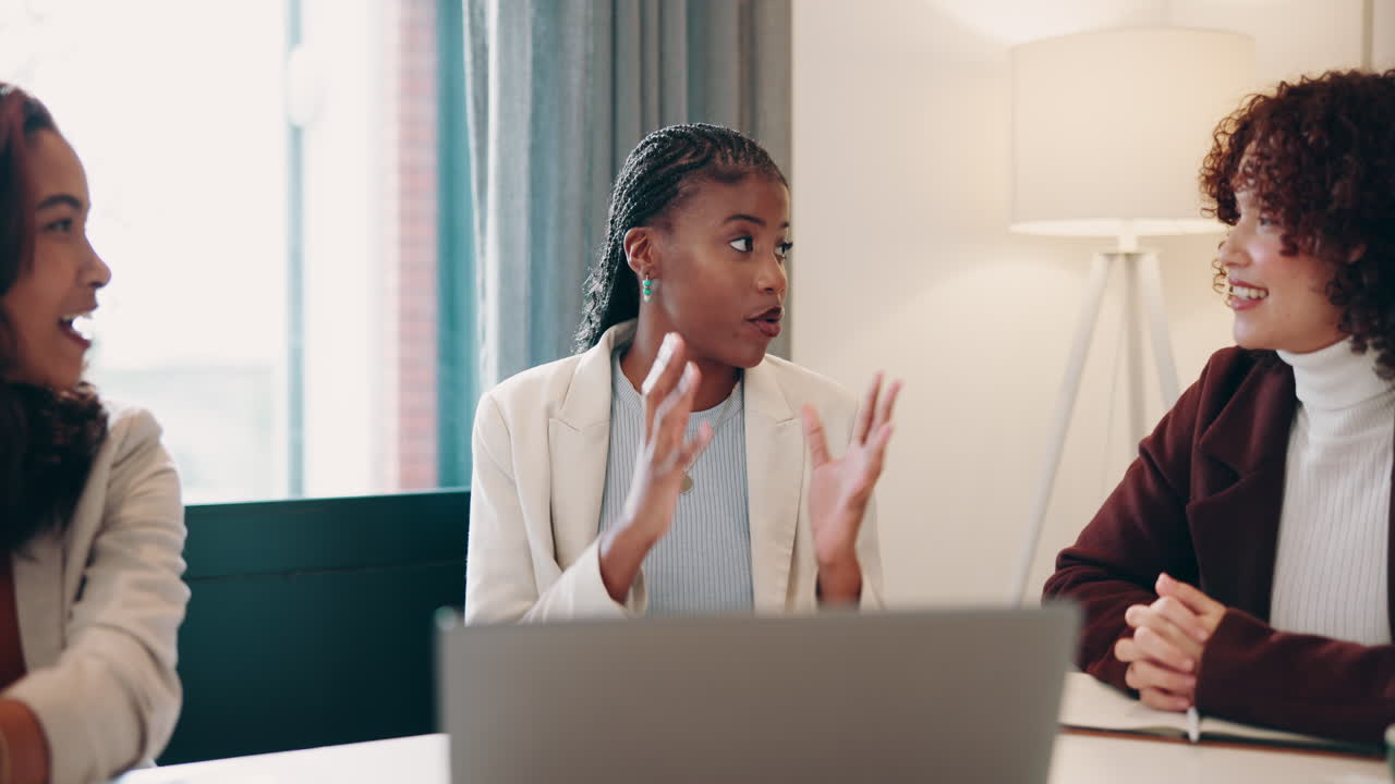 Three women in a business meeting in an office setting