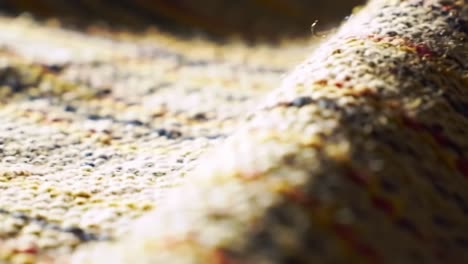 a close-up exploration of textured fabric highlighting the intricate weave and color palette in beautiful detail and softness throughout the frames