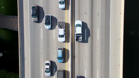 rush hour traffic with a drone looking straight down moving along with traffic