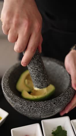 preparing avocado in a mortar and pestle