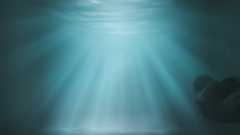 a girl floats to the surface under water against a background of sunshine